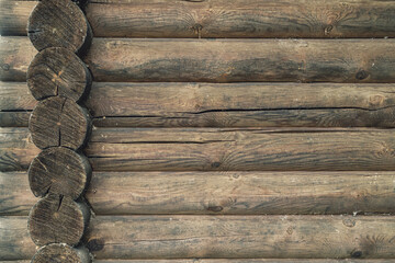 A log wall construction with a swedish cope log profile. Dirty and heavily cracked wall of a blockhouse as a background - obrazy, fototapety, plakaty