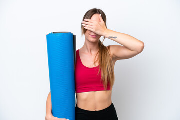 Young sport woman going to yoga classes while holding a mat isolated on white background covering eyes by hands. Do not want to see something