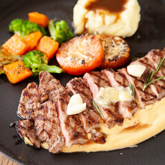 Striploin angus steak with mashed potato and grilled vegetable