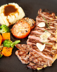 Striploin angus steak with mashed potato and grilled vegetable