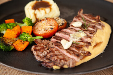 Striploin angus steak with mashed potato and grilled vegetable