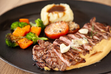 Striploin angus steak with mashed potato and grilled vegetable