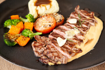 Striploin angus steak with mashed potato and grilled vegetable