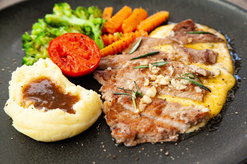 Striploin angus steak with mashed potato and grilled vegetable
