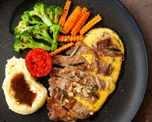 Striploin angus steak with mashed potato and grilled vegetable
