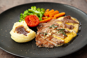 Striploin angus steak with mashed potato and grilled vegetable