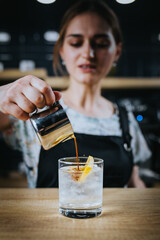Barista girl prepares iced and lemon coffee - cold refreshing invigorating summer coffee