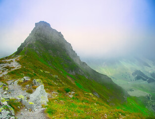 View on jagged mountain of Zillertal alps on a foggy summer day