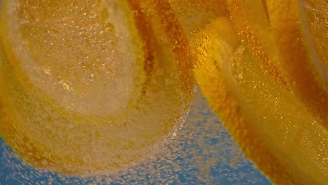 Slow Motion Shot Orange Slices into Water