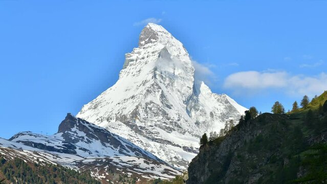 Time lapse view of Swiss alp with Matterhorn peak in sunny day Zermatt Switzerland