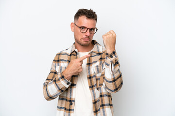 Young caucasian handsome man isolated on white background making the gesture of being late