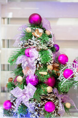 Pink Christmas balls on a decorative Christmas tree.
