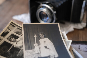 old family photographs, pictures from 1940, home archive documents, vintage film camera on wooden...