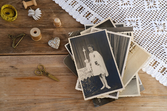old family photographs, pictures from 1940, lace doily, home archive documents on vintage wooden table, concept of family tree, genealogy, memories, memory of ancestors, family tree, nostalgia