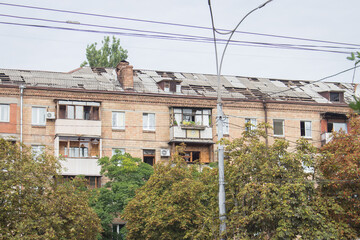 Missile attack in Kyiv, Ukraine, august 2023. Broken windows and roof after explosion. House damaged by blast wave. War in Ukraine. Russian aggression against civil people. Destroyed facade. 