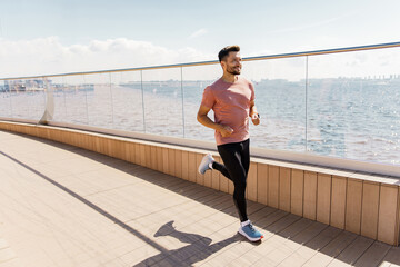 A runner does exercise every day, a healthy lifestyle. A sporty man jogging in sneakers. A man is...