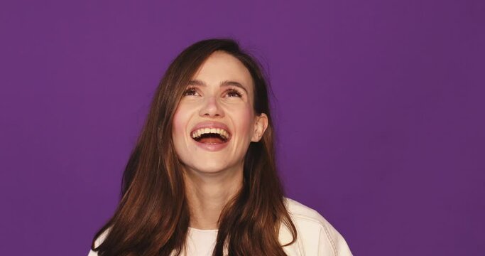 Happy joyful young woman wear jeans jacket laughing out loud after hearing ridiculous anecdote, funny joke, feeling carefree amused, positive lifestyle isolated on purple background