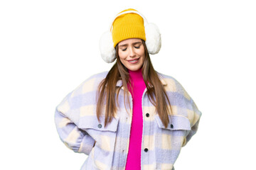 Young woman wearing winter muffs over isolated chroma key background suffering from backache for having made an effort