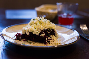 Mix of beets, cheese, mayonnaise on a plate in restaurant