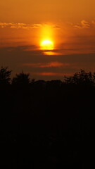 Sunset over the field near the house