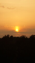 Sunset over the field near the house