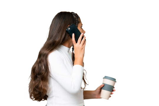 Young girl over isolated chroma key background holding coffee to take away and a mobile