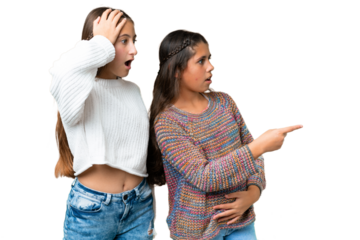 Friends girls over isolated chroma key background pointing finger to the side with a surprised face