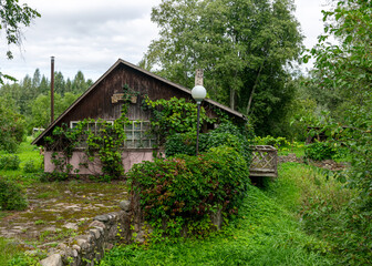 Fototapeta premium terrace of an old wooden house, wooden house on the river bank, moss covered roof