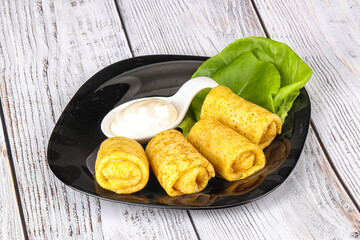 Stuffed pancakes with cream sauce