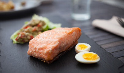 Baked salmon fillet with homemade guacamole and quail eggs halves