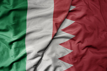 big waving national colorful flag of italy and national flag of bahrain .