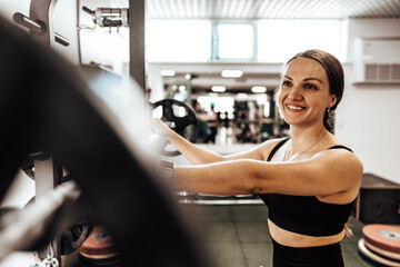 Fototapeta na wymiar Portrait of a female personal trainer in a gym