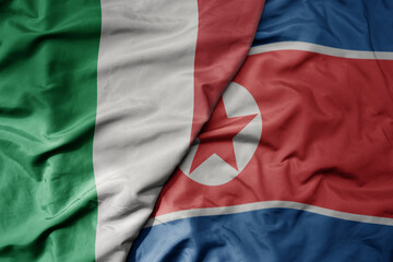 Obraz premium big waving national colorful flag of italy and national flag of north korea .