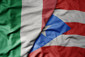 big waving national colorful flag of italy and national flag of puerto rico .