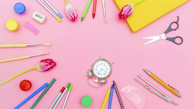 Stop motion animation of multicolor school stationery supplies tools,alarm clock are moving,appear.Back to school, education,childhood,primary school concept on pink background.Top view 4 k