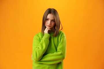Upset disturbed teen girl on yellow background