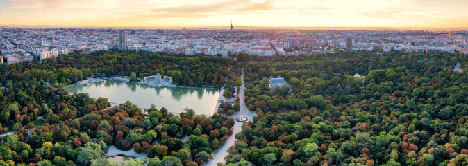 Aerial panoramic view of Parque El Retiro in Madrid, Spain at a golden hour sunrise