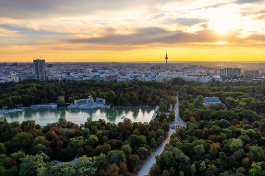 Aerial panoramic view of Parque El Retiro in Madrid, Spain at a golden hour sunrise