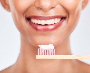 Toothbrush, toothpaste and dental with woman and closeup, health and fresh breath isolated on white background. Bamboo, mouth and teeth whitening with oral care, orthodontics and routine in studio