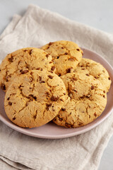 Homemade Cookies with Milk Chocolate Chunks on a Plate, side view.