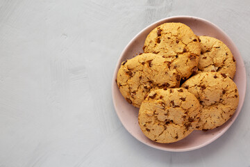 Homemade Cookies with Milk Chocolate Chunks on a Plate, top view. Flat lay, overhead, from above. Copy space.