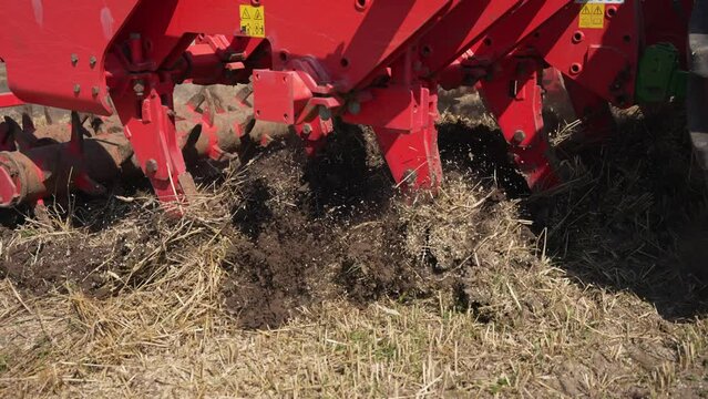 Agricultural machinery plows the land