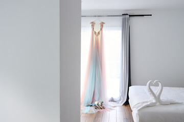 Wedding dress and veil on the bed in the bedroom