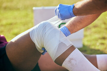 First aid, sport injury and leg bandage with soccer accident, fitness and massage on a field....