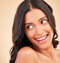 Fototapeta premium Self care, beauty and happy woman in studio with cosmetic, glamour and glow face routine. Thinking, health and Indian model with natural facial cosmetology treatment isolated by a brown background.
