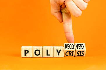 Polycrisis or polyrecovery symbol. Concept words Polycrisis Polyrecovery on wooden cubes. Beautiful orange background. Businessman hand. Business Polycrisis or polyrecovery concept. Copy space.