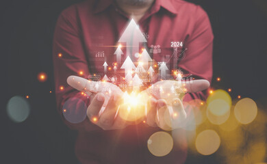 The future growth to 2024. Set target, business strategy. New Goals, Accounting, Financial, and Plans concept. Businessman holding arrows virtual screen with year 2024.