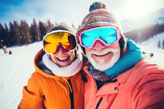 Happy elderly couple with sunglasses and ski equipment in ski resort Bukovel, having fun and taking selfie, winter holiday concept