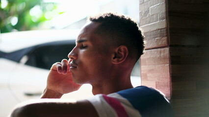 One contemplative young black Brazilian man thinking about life with hand in chin. Thoughtful...