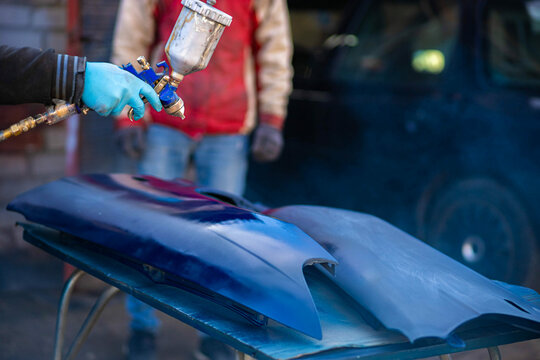 painting the elements of the car body in blue.